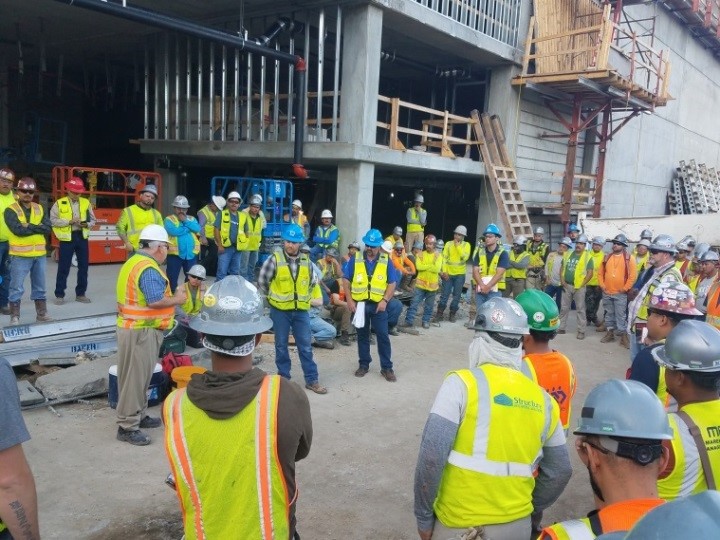 Workers discussing safety at Region 6 stand-down