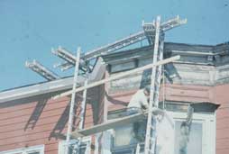 Figure 4. This job-made rig consists of some sections of scaffold decking and some aluminum ladders, hung from the roof. Who determined if it was capable of supporting its own weight and 4X its maximum intended load?