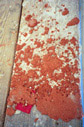 Figure 7. Accumulated layers of paint and plaster on wood plank.