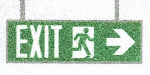 Picture 2 - proposed sign containing arrows combined with the ISO 7010 moving person symbol - does not meet requirements in NFPA 170
