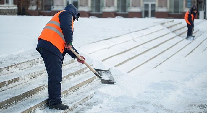 two people shoveling snow