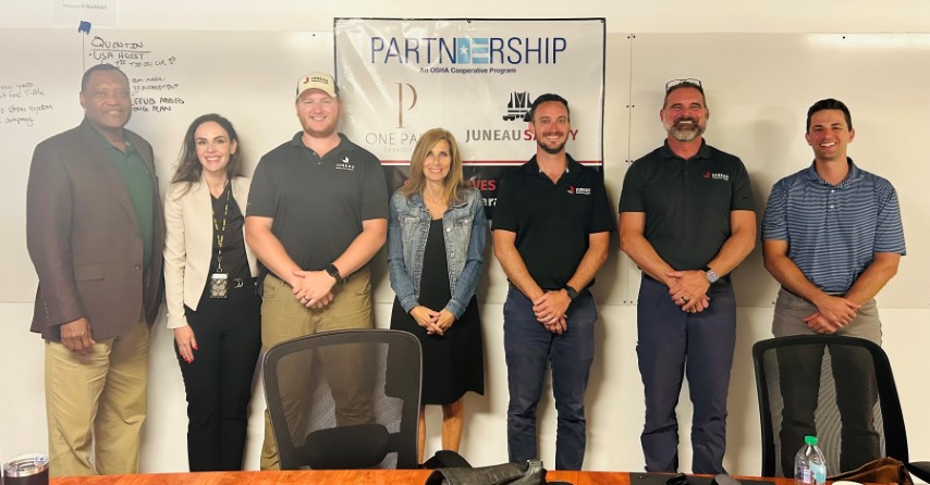 Attendees to the Partnership agreement signing ceremony stand for a group photo, after the signing ceremony.