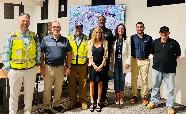 Attendees to the Partnership agreement signing ceremony stand for a group photo, after the signing ceremony.