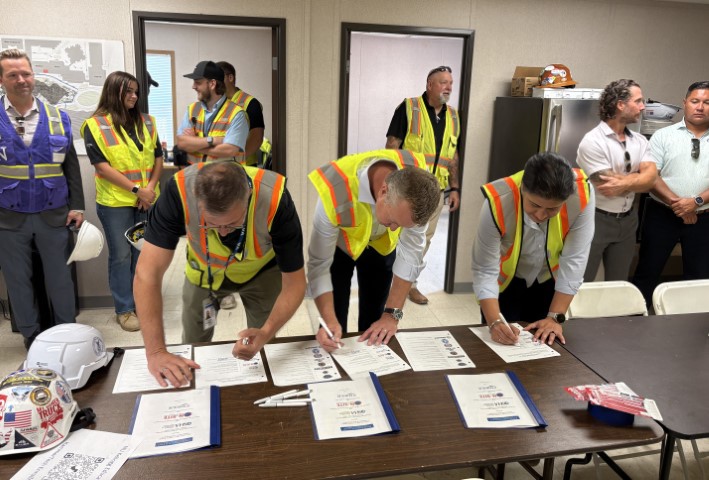 Sukhvir Kaur, Area Office Director, Chicago North Area Office; Ed Lefevour, Illinois On-Site Safety and Health Consultation Program; and Jeff Geier, President and CEO, Power Construction Company sign the Partnership agreement
