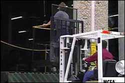 Figure 6. Specialized platform for lifting coworker. Note: There is a guard on the back of the platform to keep the person in the platform and protect the worker's arms and hands.