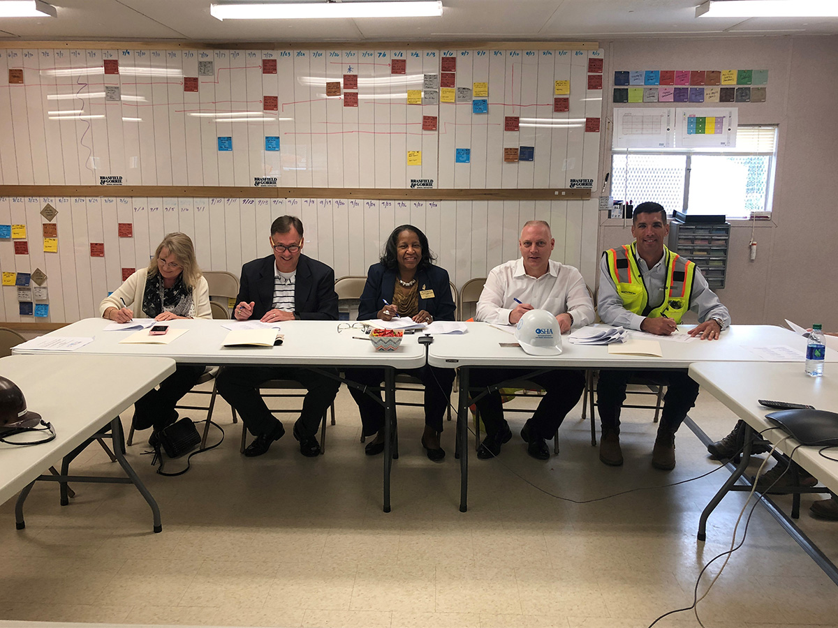(left to right): Cherri Watson, AGC of Georgia; Paul Schlumper, Manager, Georgia Tech On-Site Consultation; Myrtle Turner, Director of Safety, Health and Environmental Services and OSHA Education Center; Jeff Stawowy, Assistant Area Director, Atlanta West Area Office, US DOL-OSHA; and Steve Sawyer, Regional Safety Director, Brasfield & Gorrie, LLC. sign the agreement.