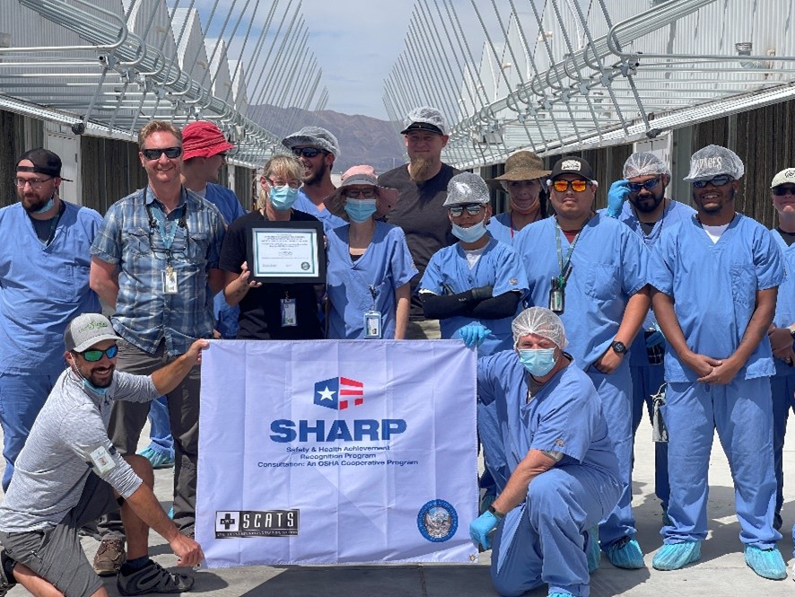 Employees holding their SHARP flag