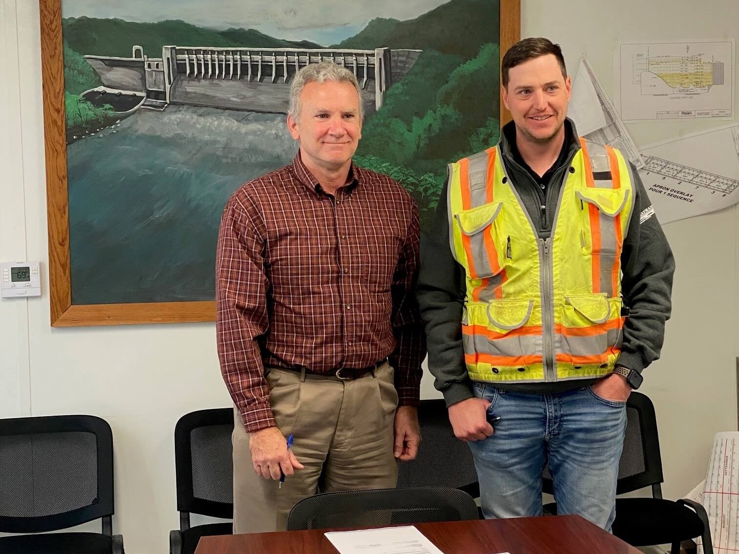 Blake McEnany, OSHA, and Logan Hamilton, Brayman Construction Corporation, stand together after signing the Partnership agreement.