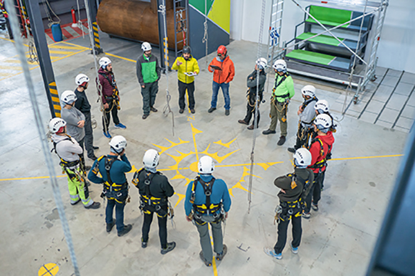 Construction workers gathered in a circle having a meeting