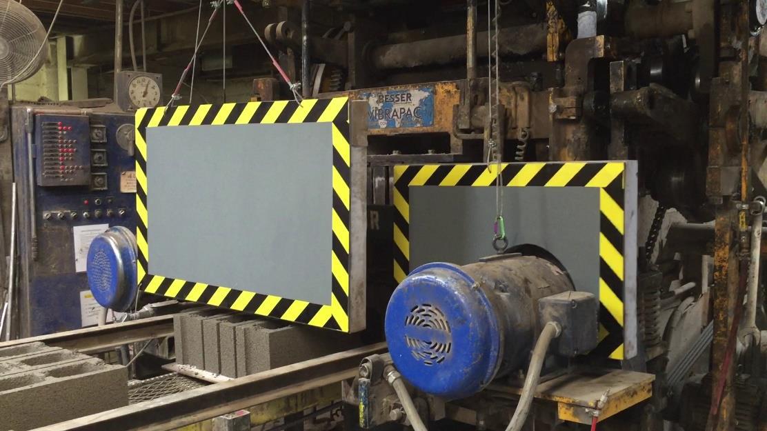 Concrete block maker with noise shields