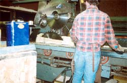 Worker and operating controls too close to rotating saw blades.