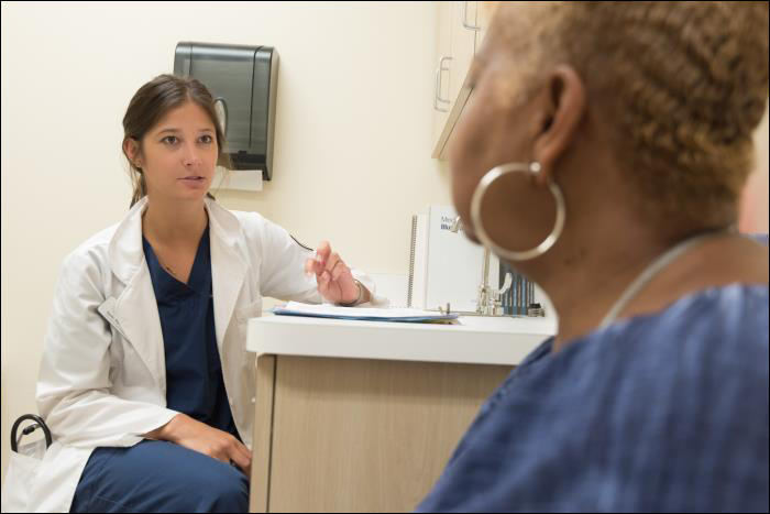 healthcare worker with patient | Photo Credit: CDC/Scott Housley