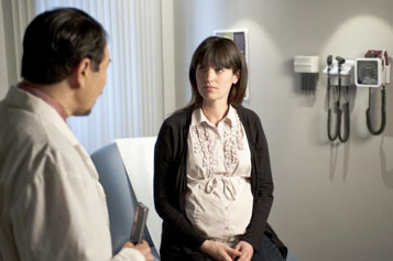 Medical professional talking with a patient in examination room | Photo Credit: Centers for Disease Control and Prevention