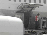 Figure 4. Baggage bins are mechanically moved into the plane and into position.