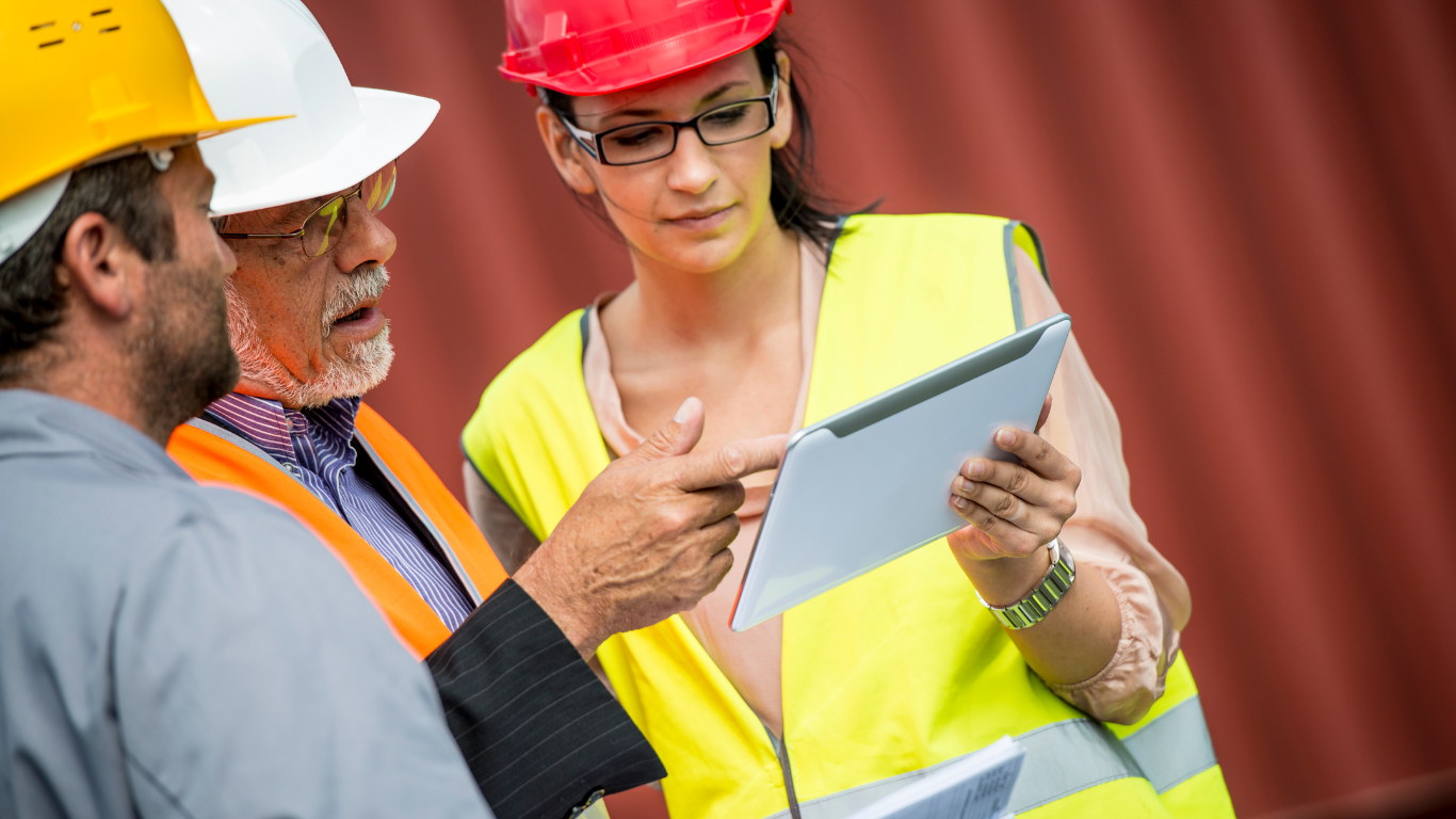 Workers in hard hats reviewing safety instructions