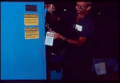 Figure 5. An employee follows lockout/tagout procedures for plastics machinery needing repair.