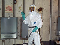 Figure 13: Worker with disposable suit, gloves and face protection