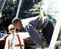 Man hanging from a body belt around the waist