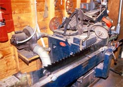 Band saw sharpening machine #1. Note the unguarded abrasive wheel.