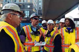Photo Credit: OSHA News Photo/Shawn Moore - A team of responders discusses emergency operations at a disaster site.