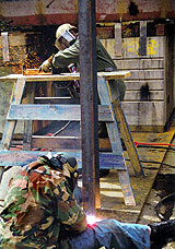 Figure 11: Worker protected by eye and face protection while grinding