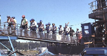 Figure 1: Workers on a properly guarded gangway