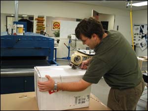 Figure 23. Awkward posture due to incorrect table height for packaging box.