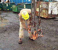Figure 1: Rigger inspecting wire rope slings and shackles before use