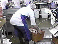 Worker lifting tub off floor