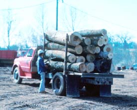 Worker releases load binders from the side opposite the unloading side.