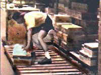 Person bending at waist to reach product on floor level