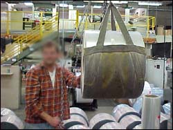 Figure 34. Material handling equipment safely lifts heavy rolls of substrate.