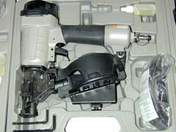 Handheld nail/stapling gun in case with attachments