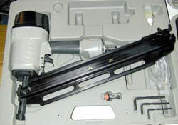 Handheld nail/staple gun in carrying case