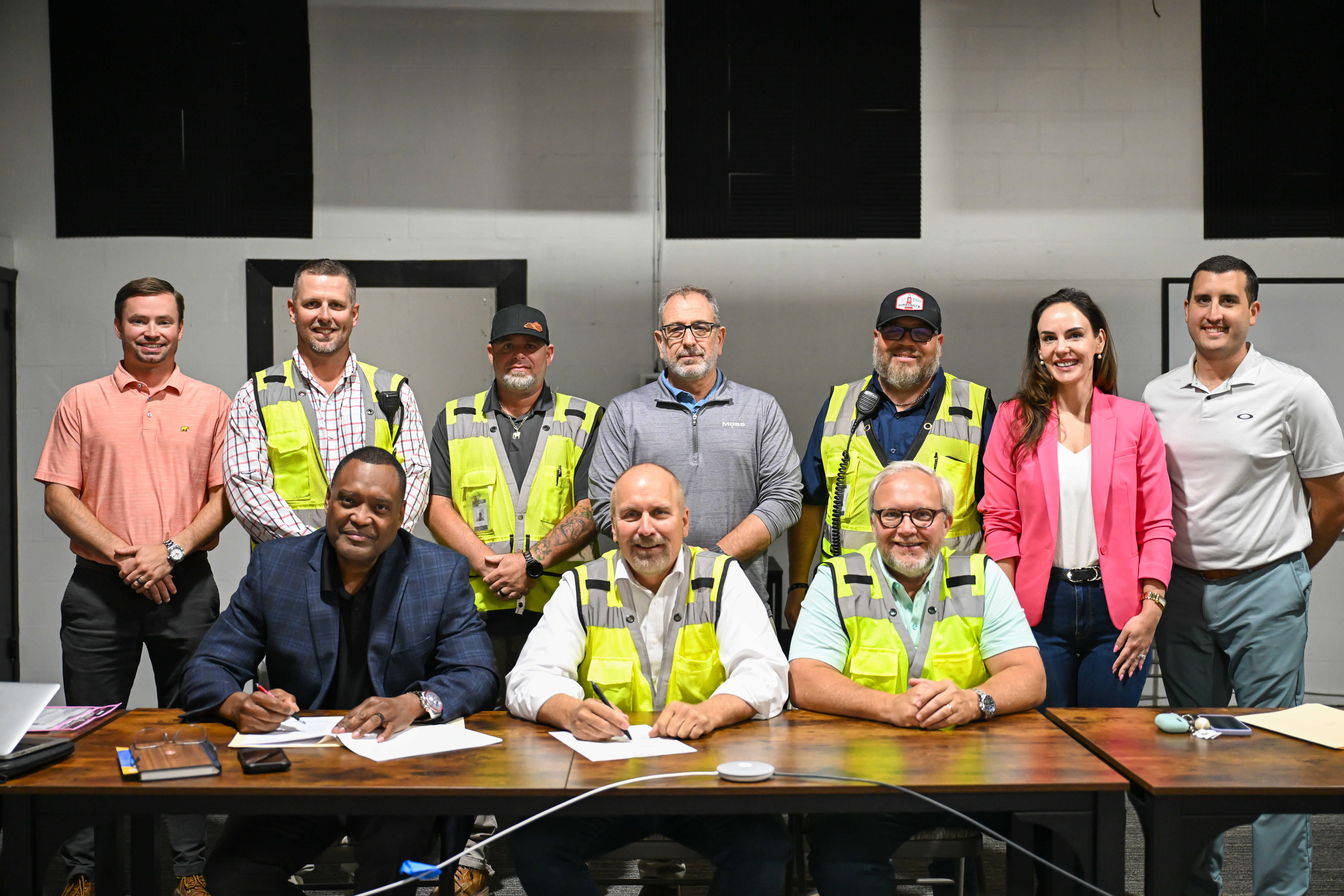 Attendees to the Partnership agreement signing ceremony pose for a group photo, after the signing ceremony.