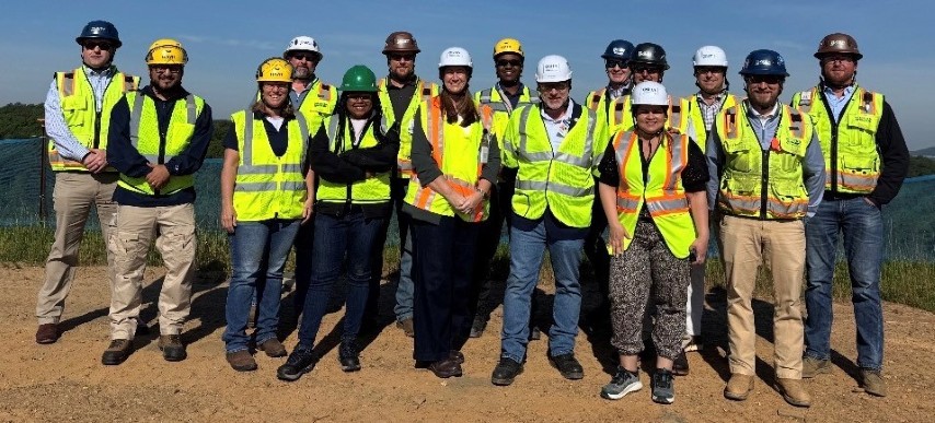 Representatives from OSHA, Georgia On-Site Safety and Health Consultation and workers with Brasfield & Gorrie, LLC, pose for a group photo at the worksite, after the Partnership agreement signing ceremony.   