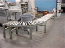 Figure 41. Use a conveyor system to move product to the palletizing position.
