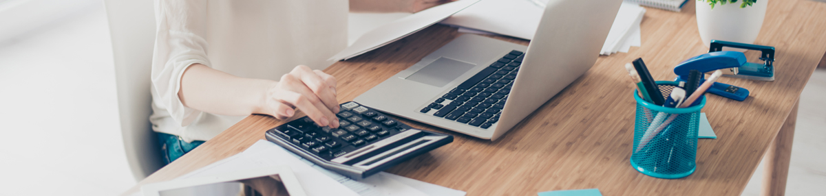 Photo of person using a computer and calculator