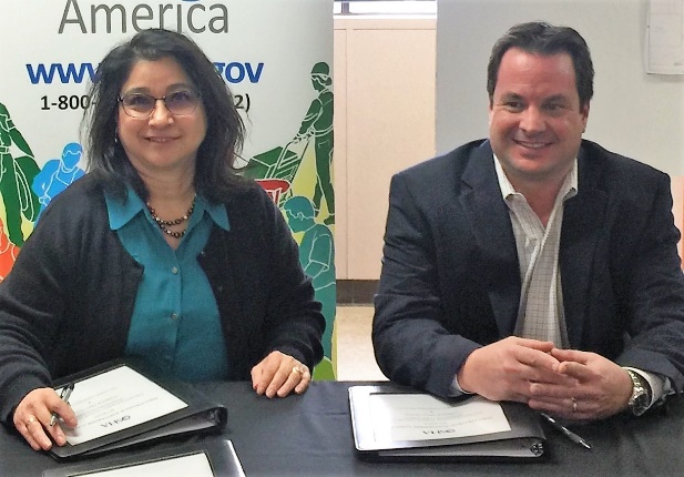 OSHA Lubbock Area Director Elizabeth Routh and Jason Smith of Lee Lewis Construction sign alliance to protect construction employees.