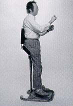 Man standing against equipment to show correct posture