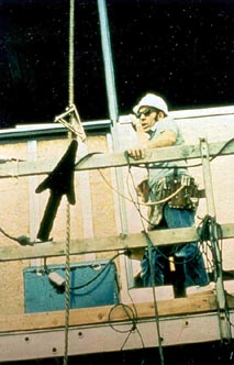 Figure 10. An example of a lanyard attached to a vertical lifeline. Note that the worker is wearing a safety belt, whereas the new standard requires a full body harness.