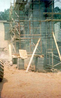  Poor foundation: Scaffold end frames, which have no base plates, erected on top of scrap wood and unstable cement blocks.