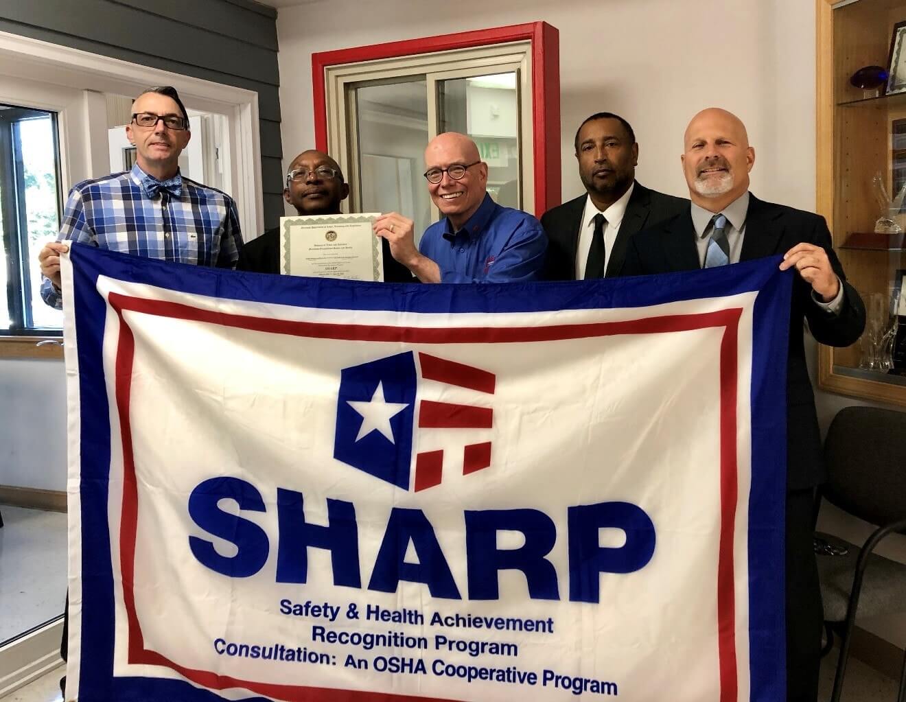 Barry Dillow, MOSH Lead Safety Consultant; William Dallas, Assistant Commissioner of MOSH; Neill Christopher, COO of Acadia Windows and Doors, Inc.; John Delgado, MOSH Lead Health Consultant; and Brad Meushaw MOSH Acting Consultation Program Manager