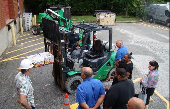 Participants learning interviewing techniques from a MOSH safety consultant during a breakout session.  In this session, participants conducted mock interviews of forklift operators.