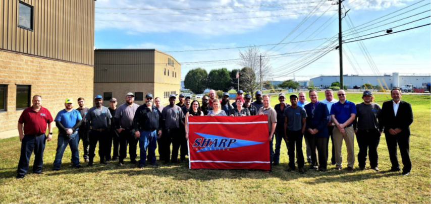 (Employees Standing with SHARP Flag)