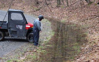 Driver assessing a creek crossing