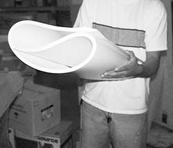 Figure 44. Worker using the trifold technique for lifting large sheets of paper.