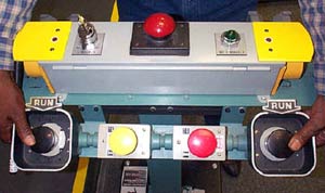 Two-hand tripping device