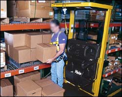 Figure 3. Order picker operator using full body harness.