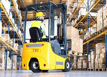 Warehouse worker driving a forklift